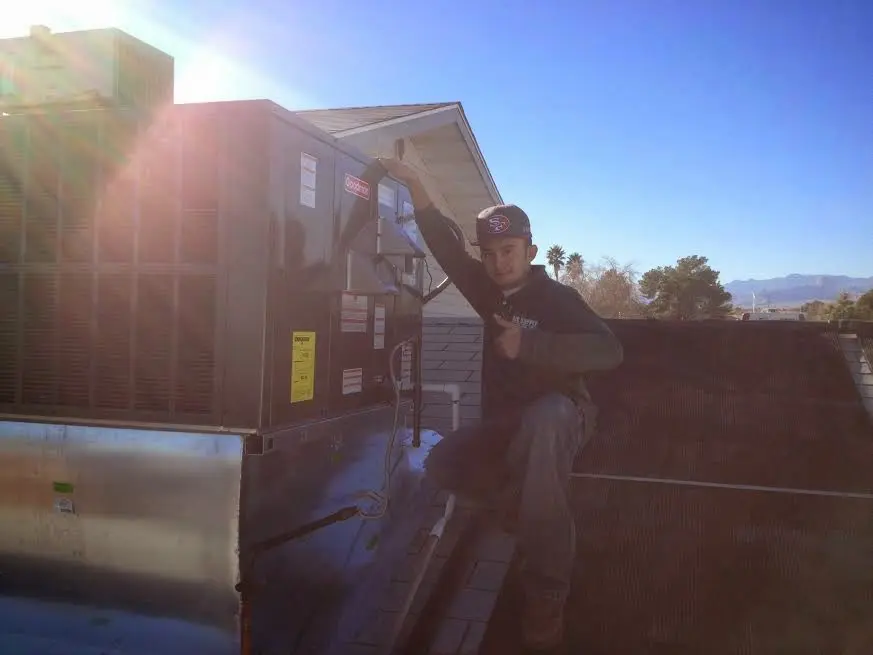 HVAC technician performing HVAC Inspection on a rooftop unit in Shelby